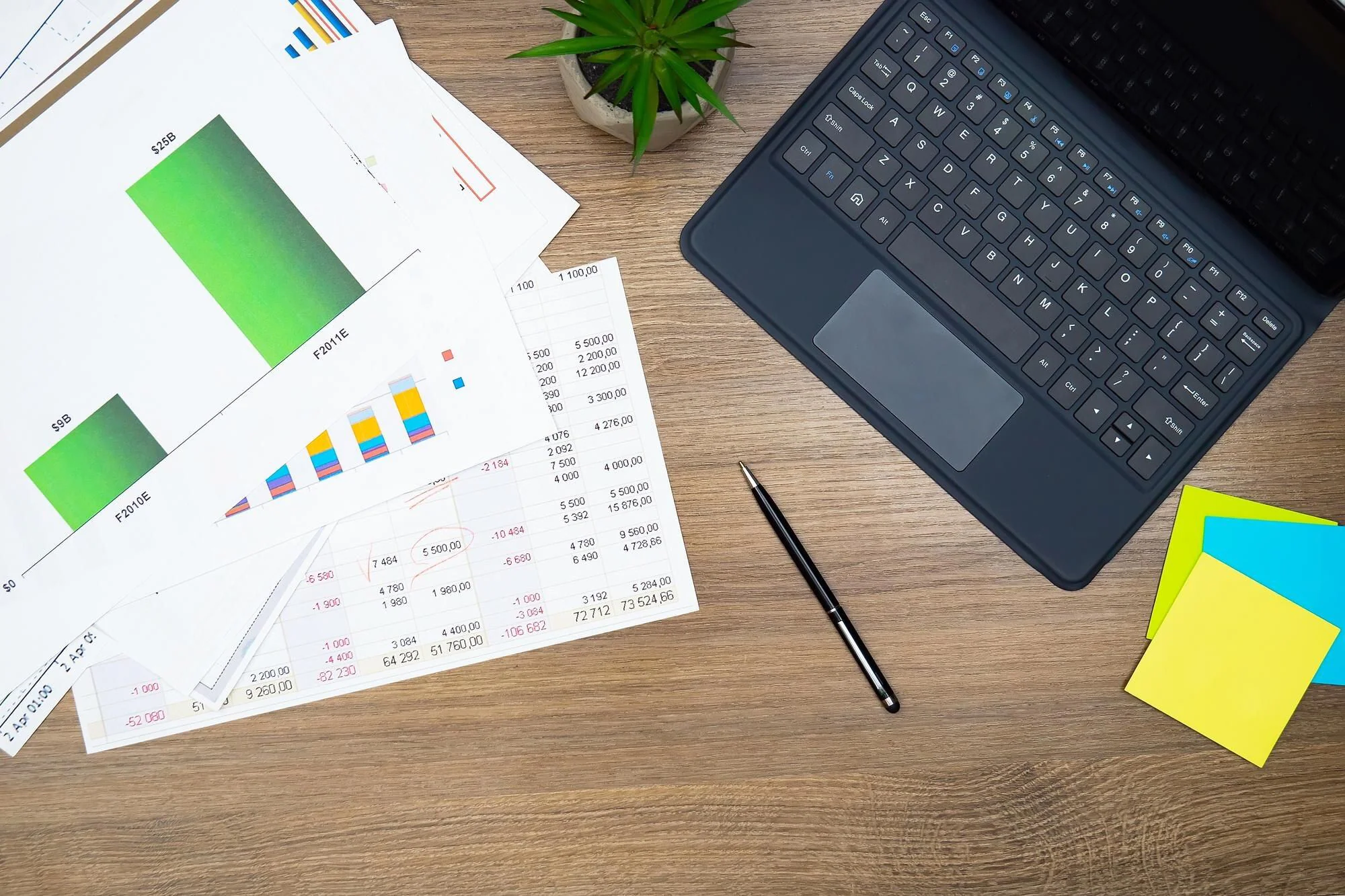 Affärsarbetsplats med laptop, diagram och rapporter som illustrerar arbete med företagsbudget